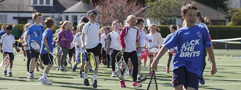 Children running with tennis rackets at Clarkston Tennis Club