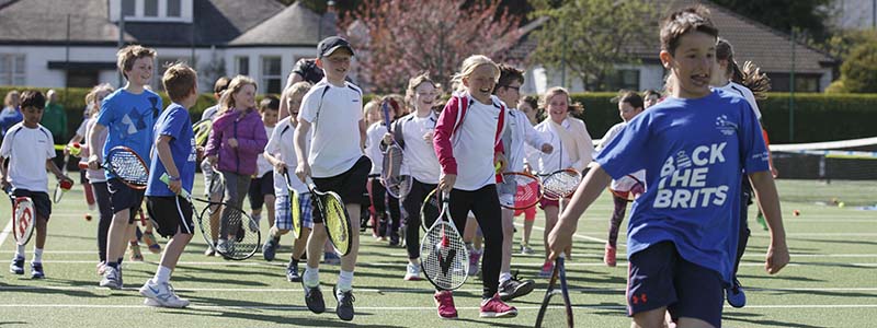 Children running with tennis rackets at Clarkston Tennis Club