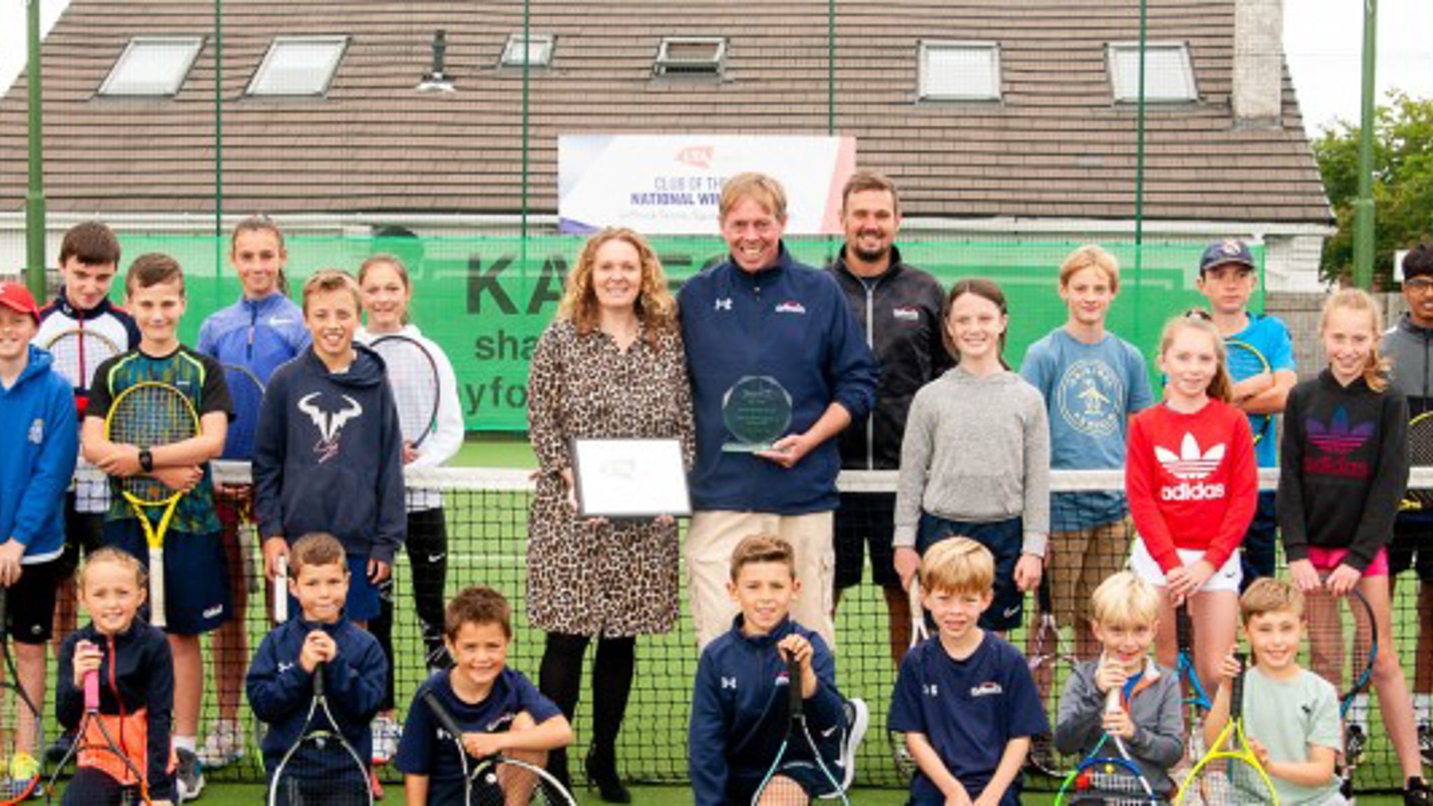 Gourp of kids holding rackets
