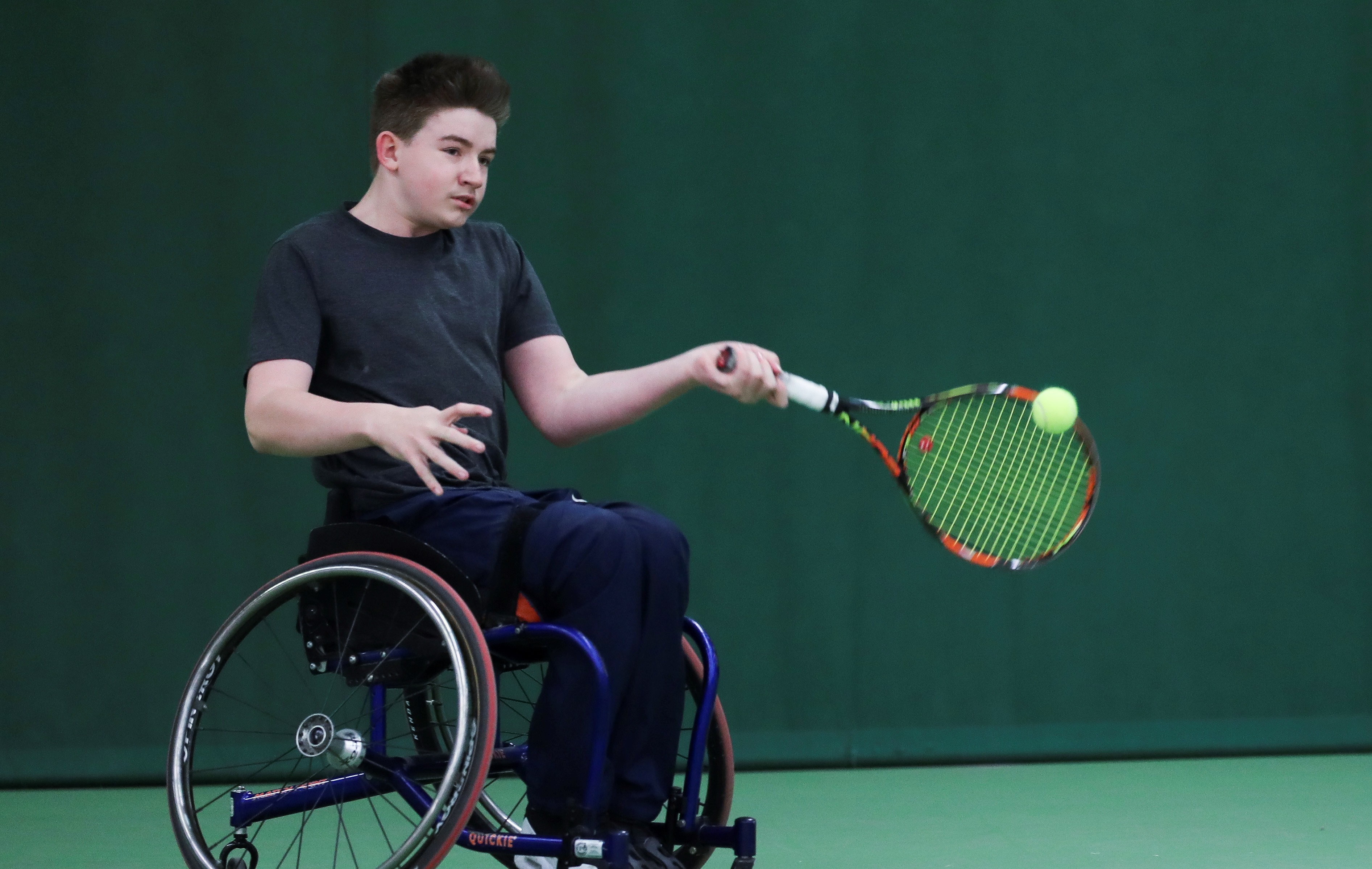 Ruairi Logan hitting a forehand