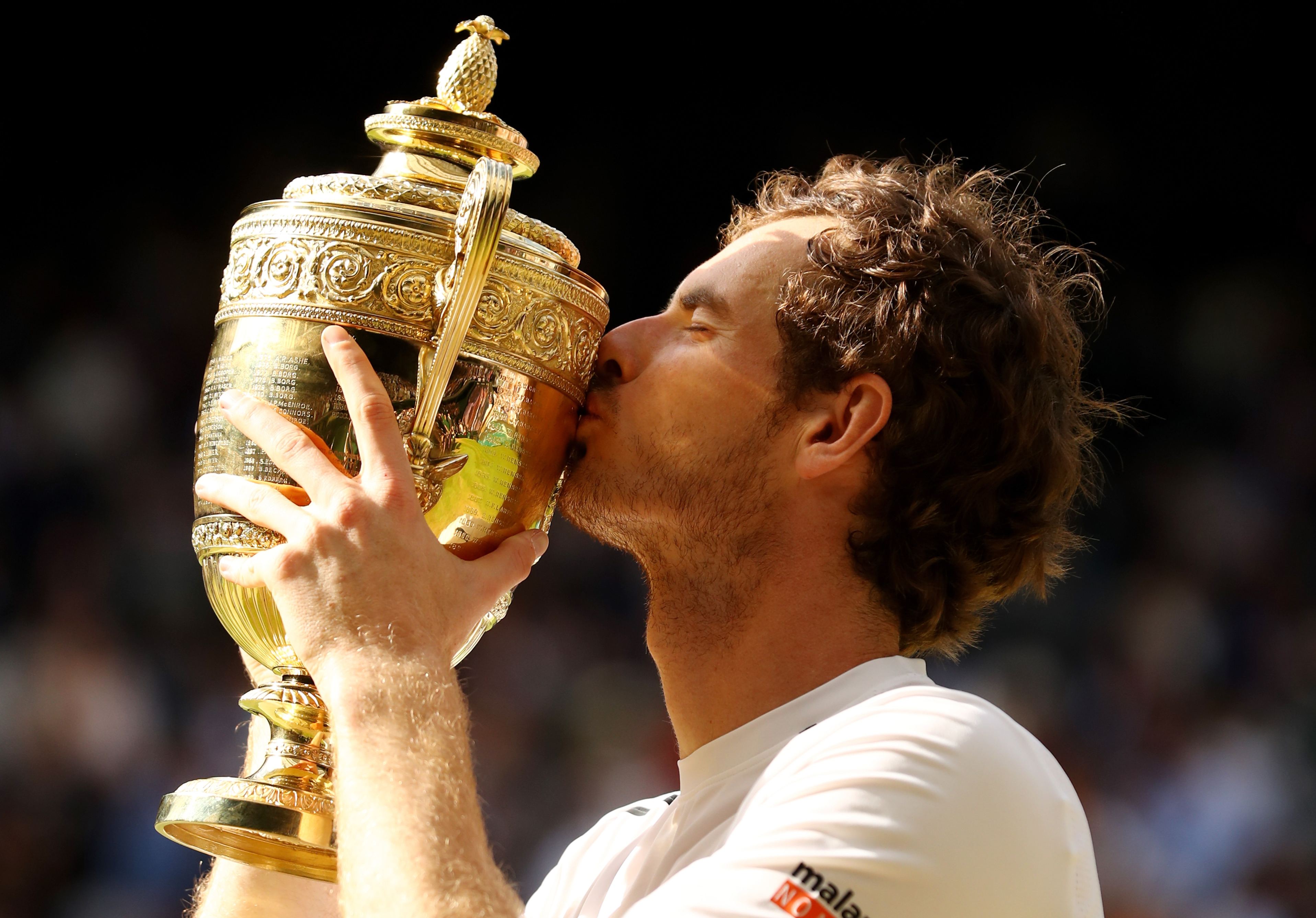 Andy Murray kisses the trophy after being crowned Wimbledon champion for the second time in his career