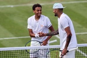 Paul Jubb shakes hands with Nick Kyrgios at Wimbledon