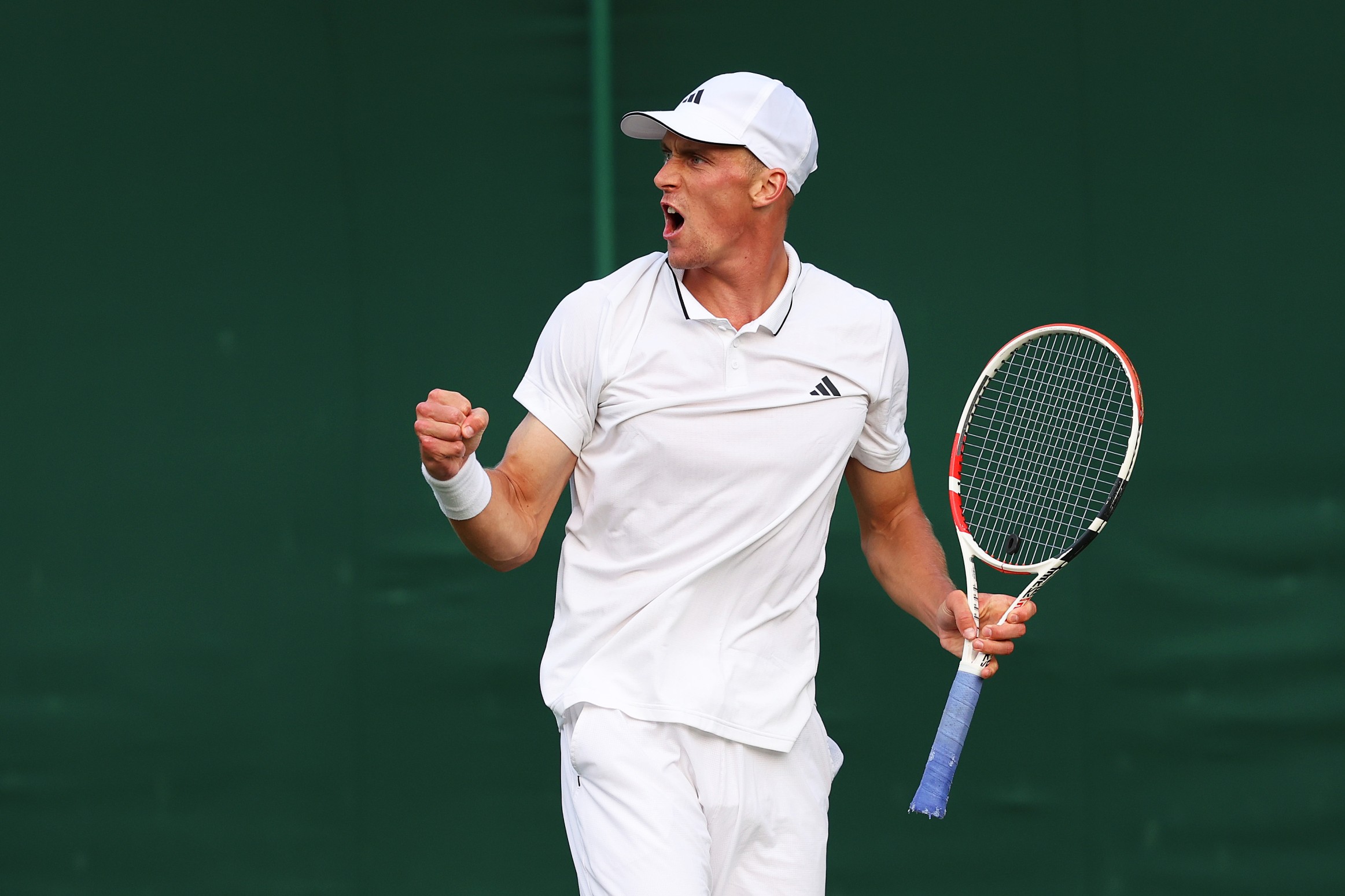 Jan Choinski celebrating match point after winning his opening round at The Championships Wimbledon 2023