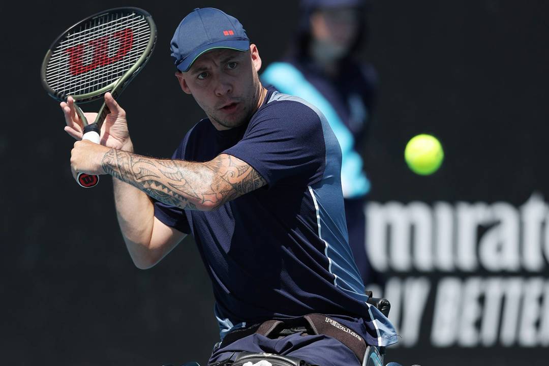 British quad tennis player Andy Lapthorne preparing to hit a backhand slice on court at the 2024 Australian Open