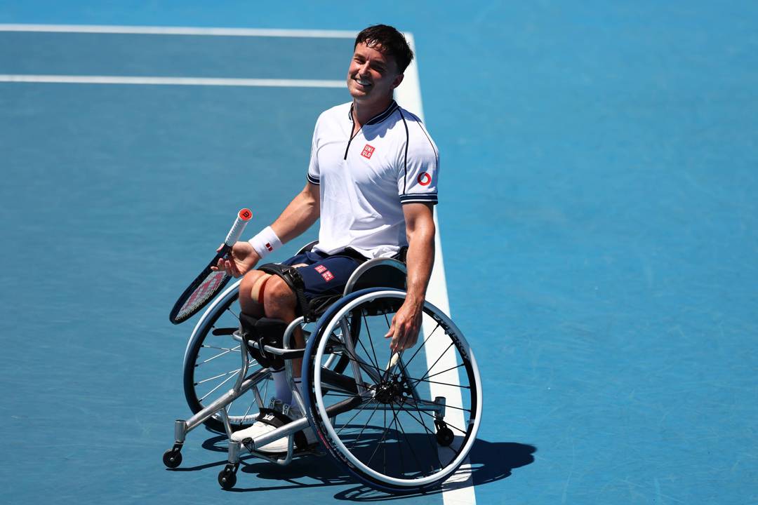 Gordon Reid sat in his wheelchair on court while smiling at the Australian Open