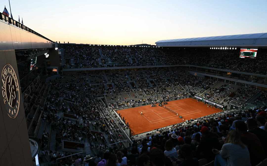 A general view image of a crowd watching two tennis players compete at Roland Garros