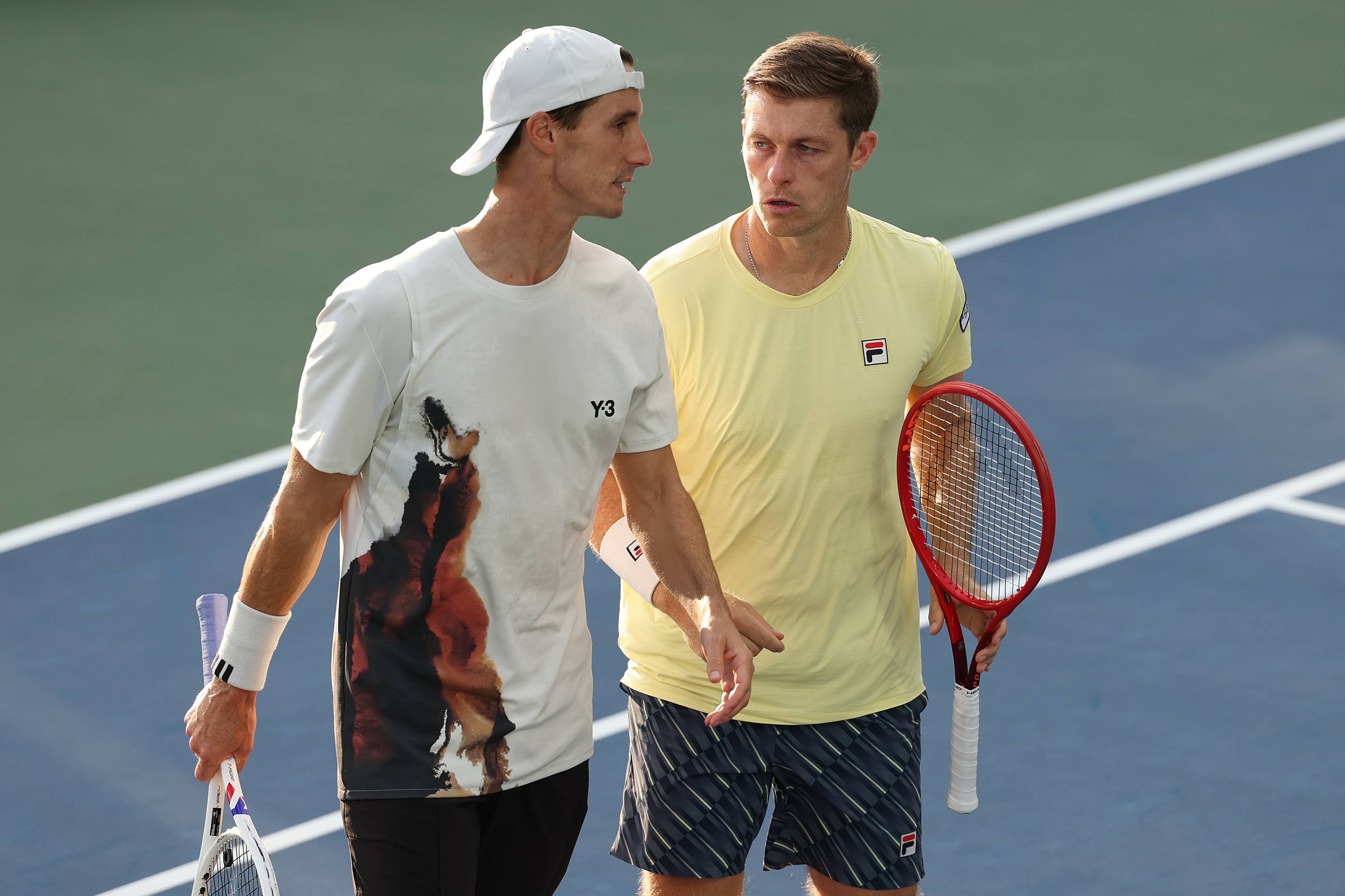 Joe Salisbury and Neal Skupski talking on court during their third round win at the 2025 US Open