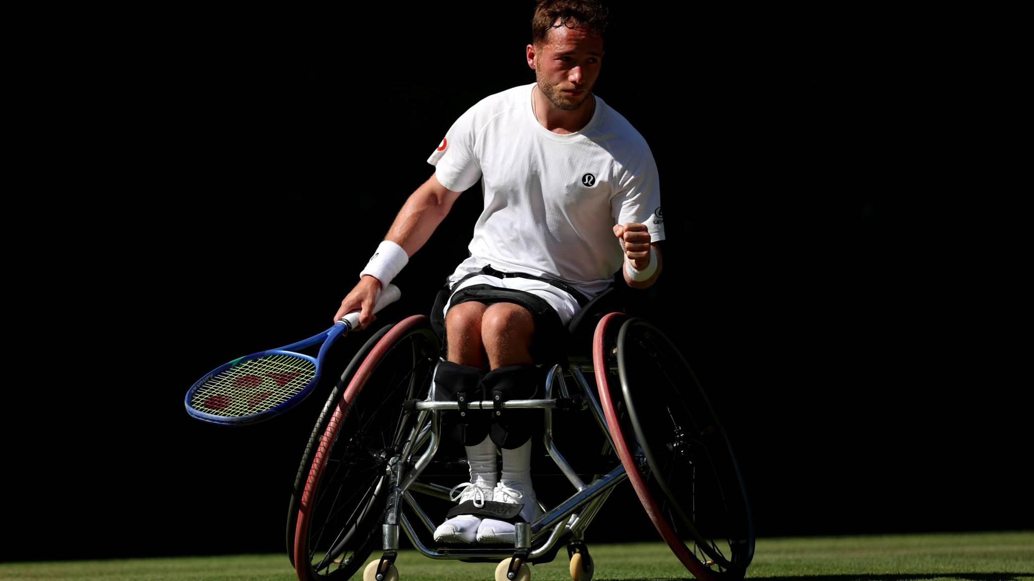 Alfie Hewett pumps his fish in celebration on the grass court
