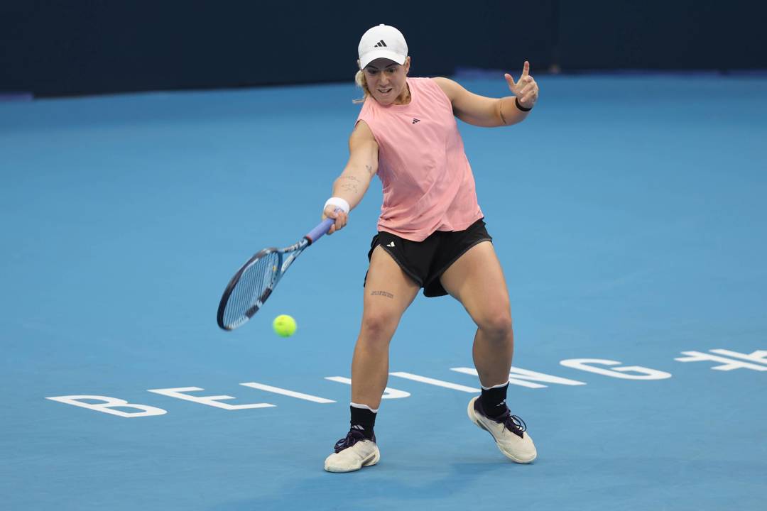 British tennis player Sonay Kartal bending down low to hit a forehand on court at the China Open
