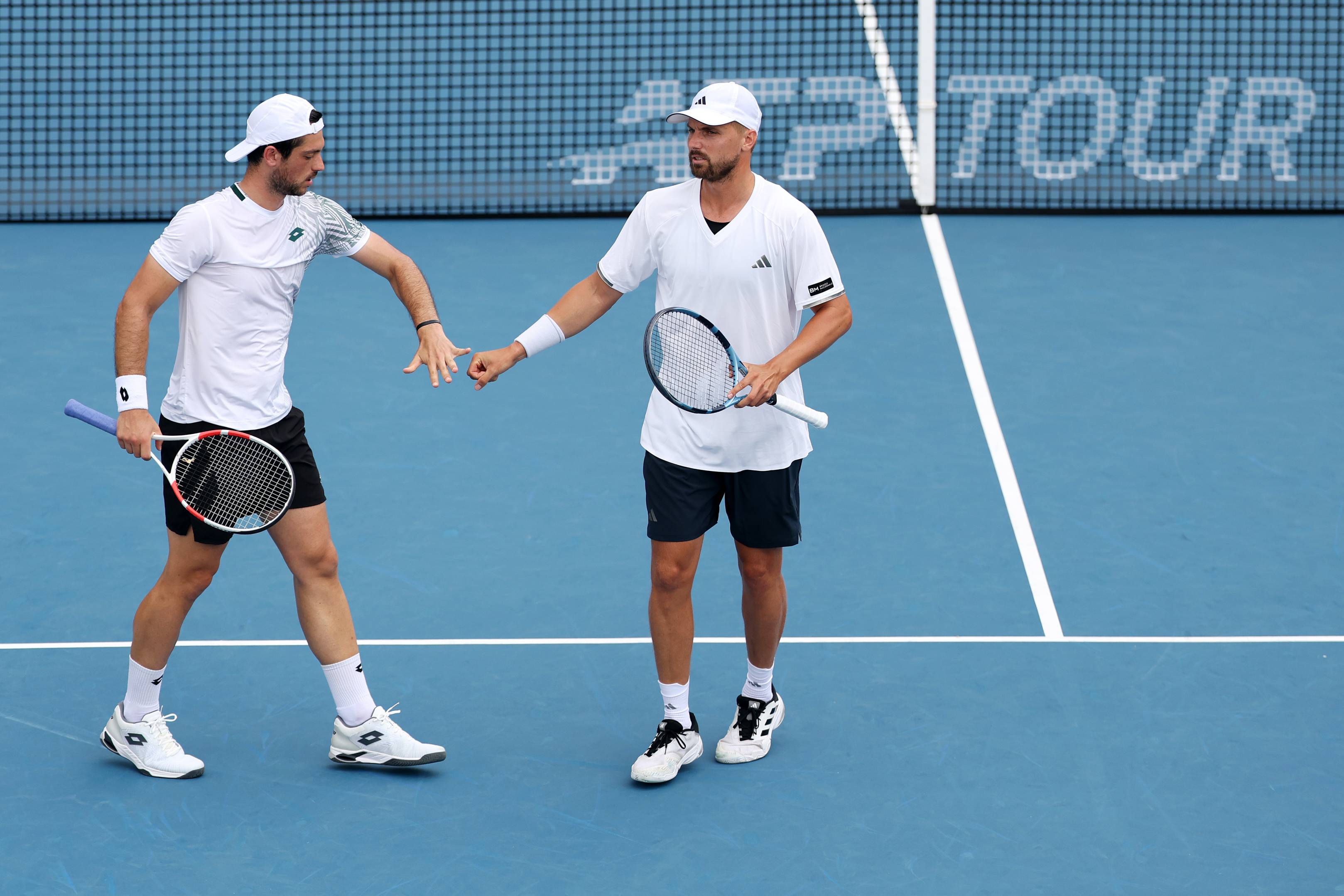 Julian Cash and Lloyd Glasspool high five during the Citi Open men's doubles final