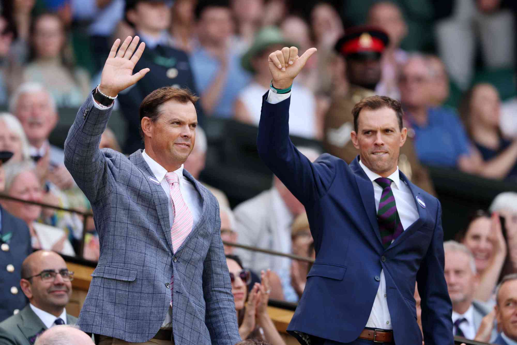 Former American tennis players Bob and Mike Bryan waving to the crowd in the Royal Box