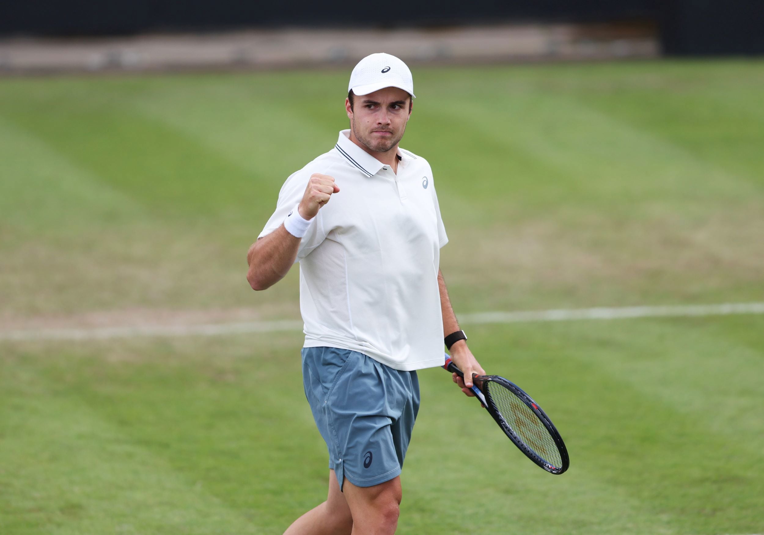 Arthur Fery pumps his fist in celebration after winning a point in the first round of Lexus Birmingham Open