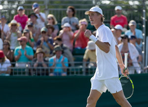 Henry Searle clenching his fist in celebration on court at Wimbledon qualfiying