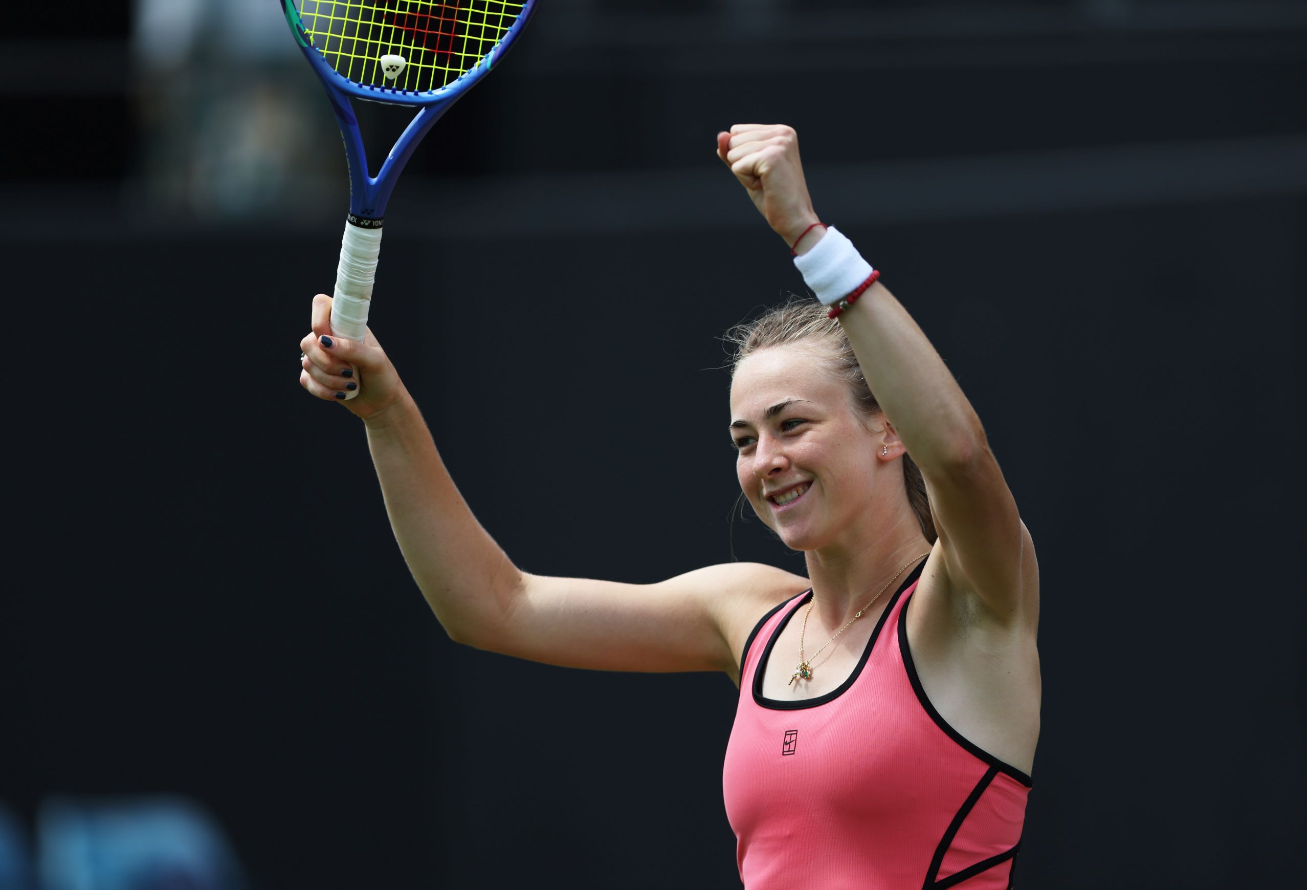 Mika Stojsavljevic holding both hands in the air and smiling on court at the Lexus Nottingham Open