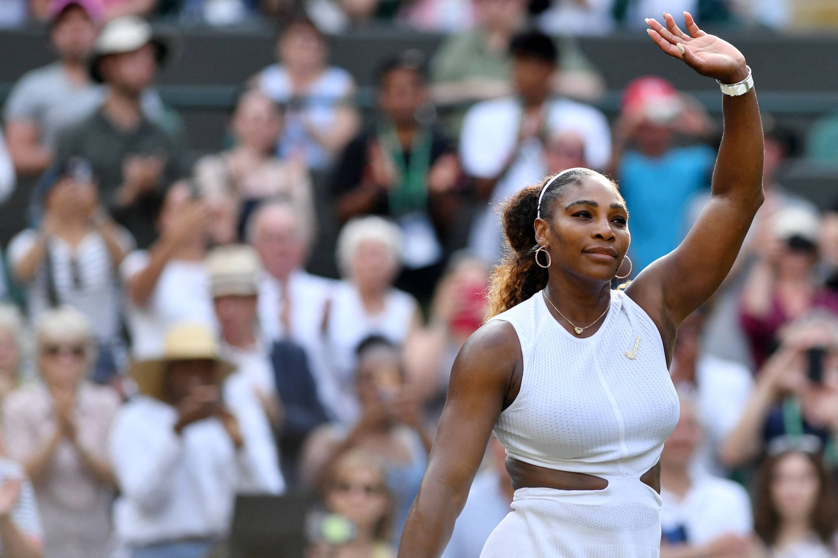 Serena Williams waves to the crowd following a match at Wimbledon