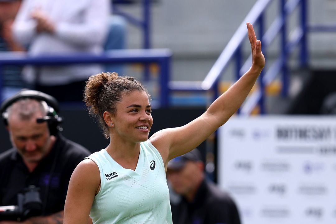 Italian tennis star Jasmine Paolini holding her hands up and waving to the crowd after winning at the Lexus Eastbourne Open
