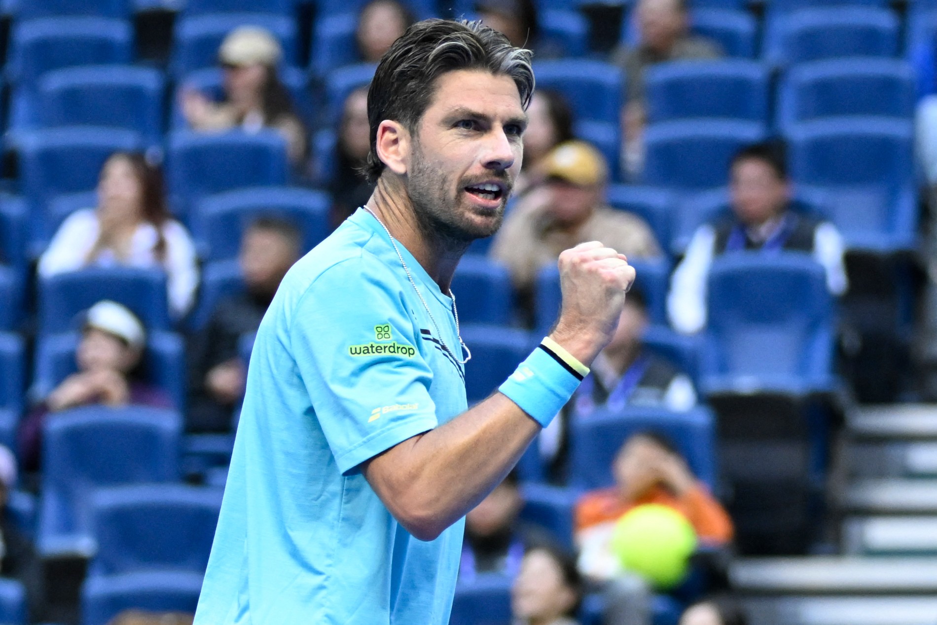 Cam Norrie gives a fist pump in celebration after winning a point at the China Open