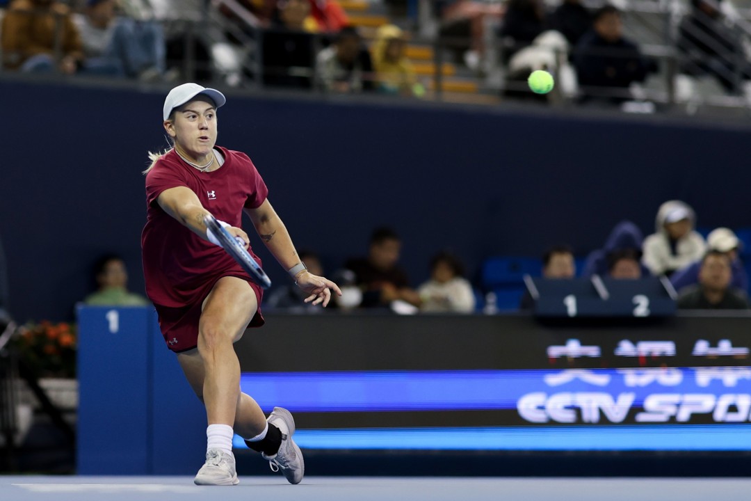 British tennis player Sonay Kartal stretcing forward to return a tennis ball on court at the China Open