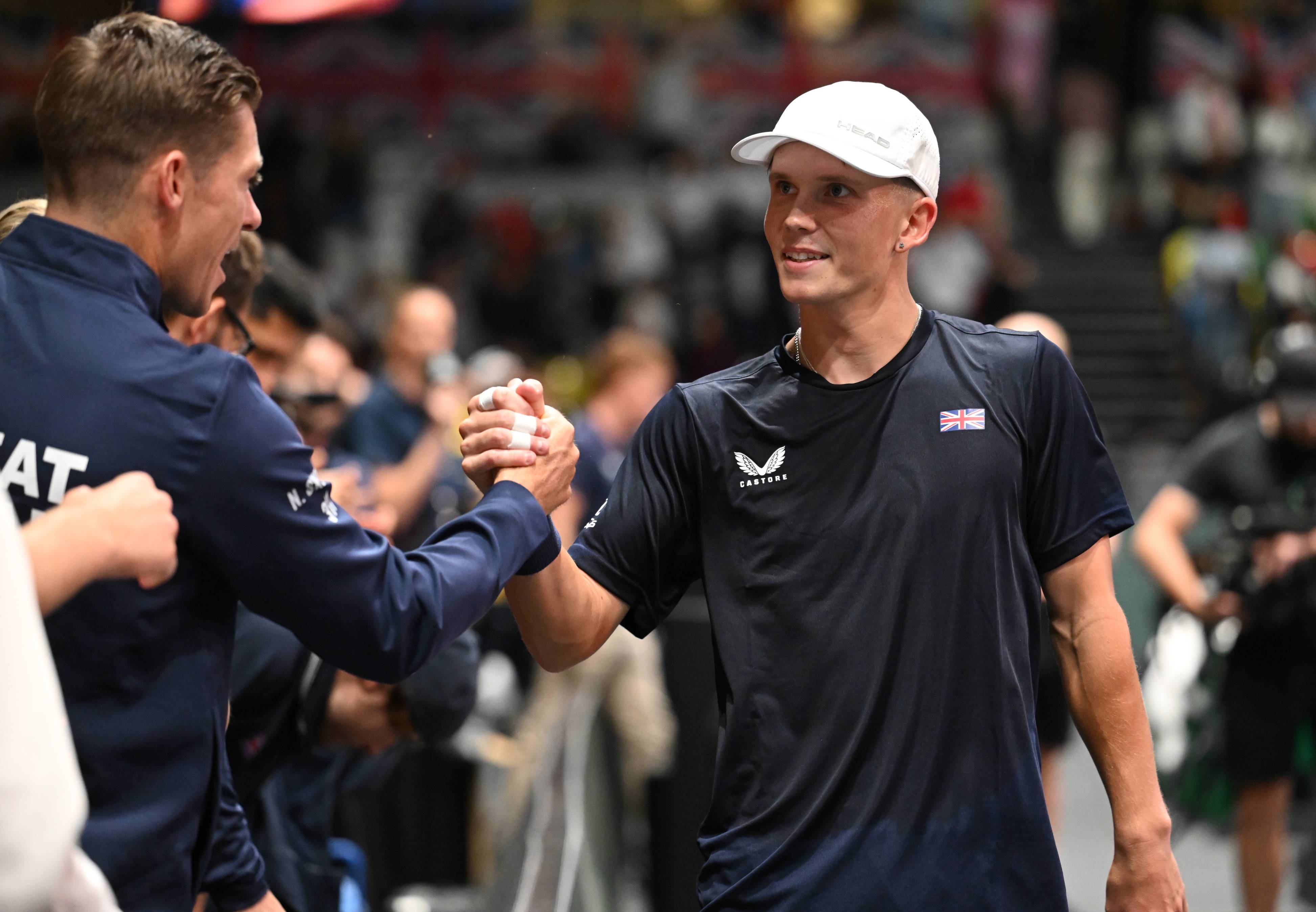 British tennis player Harry Wendelken shaking hands with fellow Brit Neal Skupski on court after winning his first tennis match for the Lexus GB Davis Cup team 