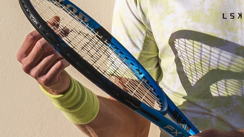 Tennis player fixing the strings on their tennis racket