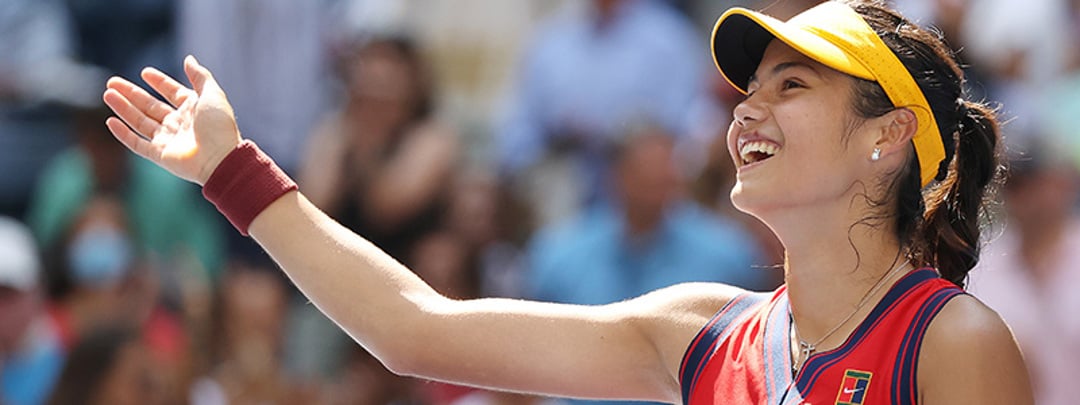 close up of emma raducanu smiling and waving hand out